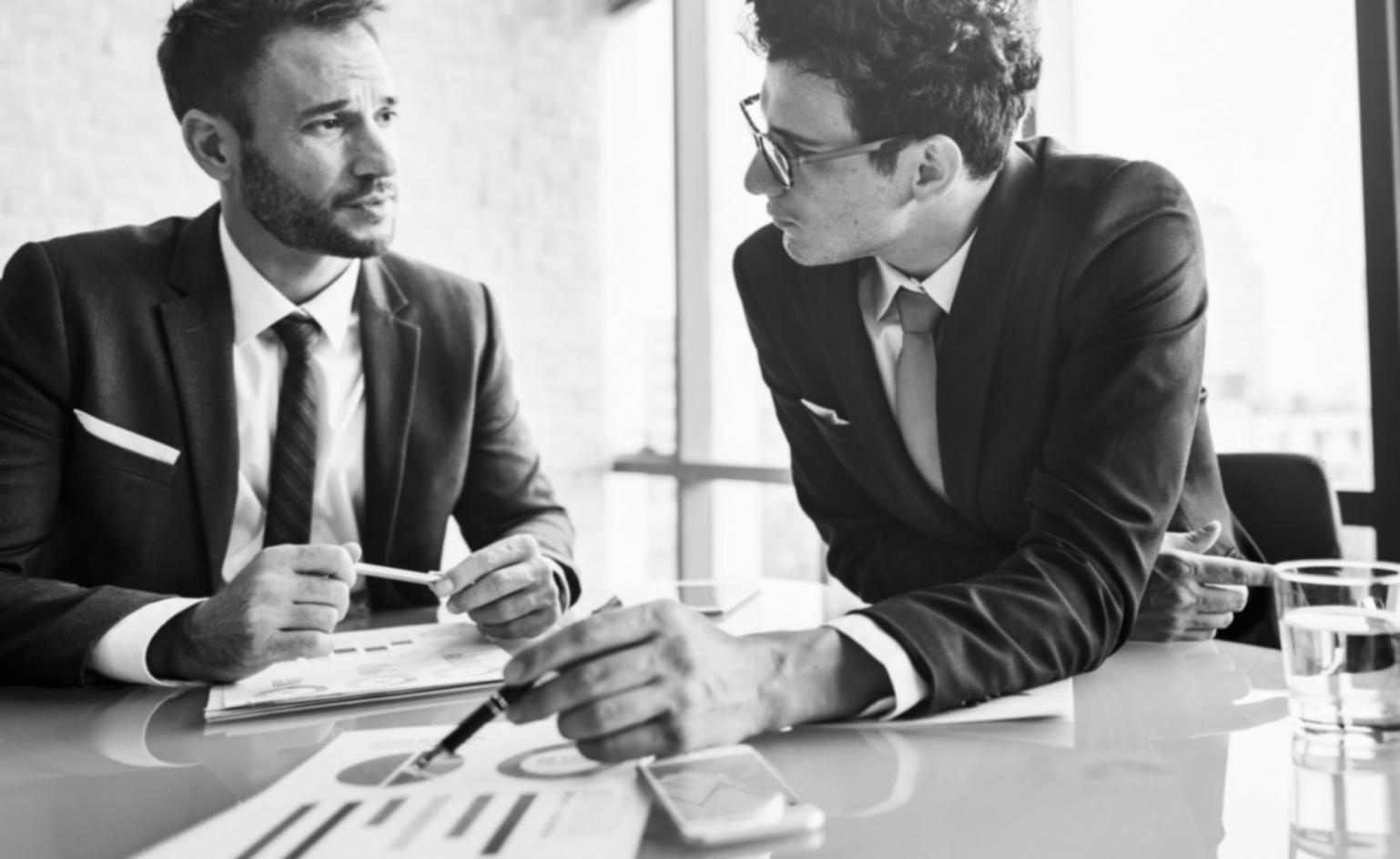 Trading psychology mentor reviewing market analysis